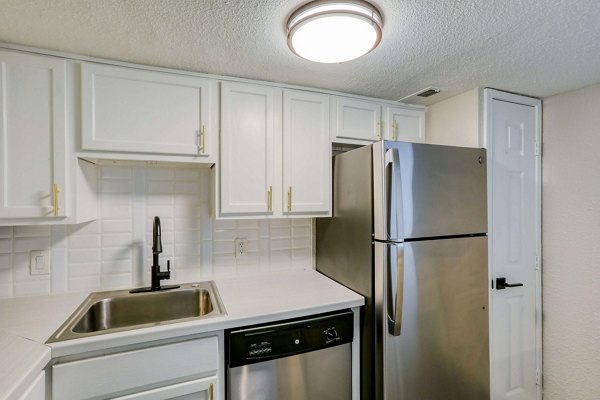 Modern kitchen with stainless steel appliances at The Lumiere Apartments in Metairie, LA