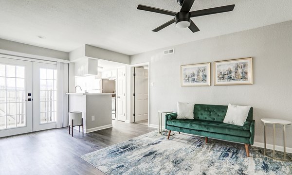 Modern living room with elegant furnishings in The Lumiere Apartments, featuring floor-to-ceiling windows for natural light