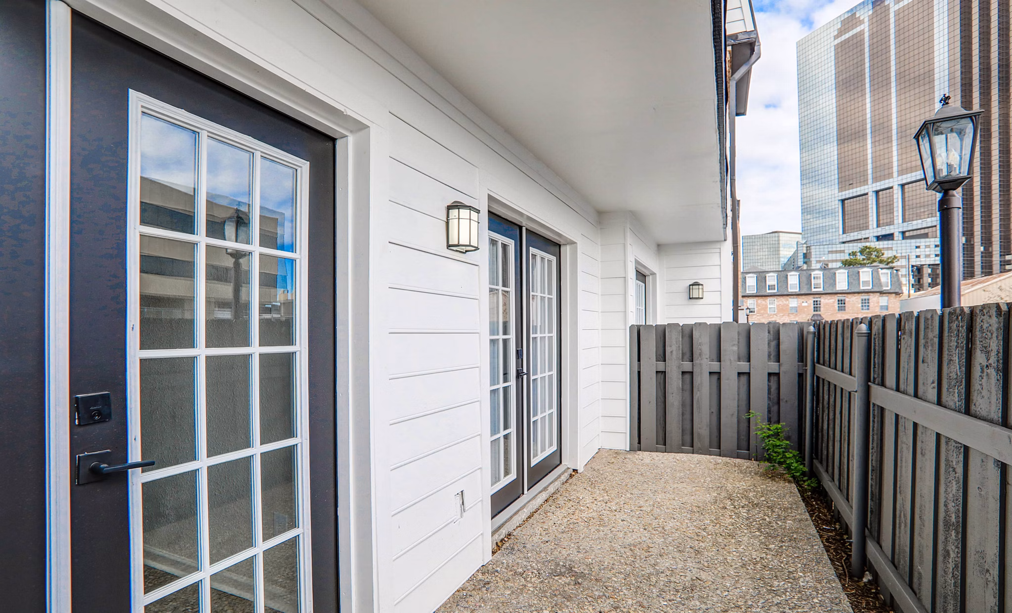 Modern outdoor patio with seating and garden at The Lumiere Apartments