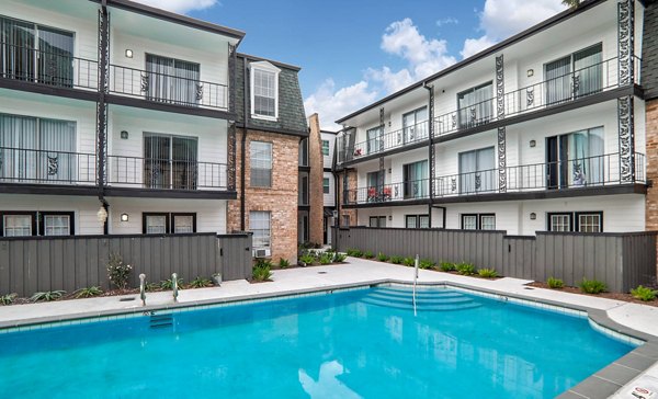 Pool with stylish loungers at The Lumiere Apartments offering luxury outdoor relaxation