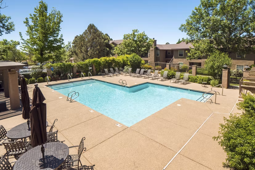 Resort-style pool with sun loungers at Hunters Ridge Apartments, a Greystar luxury community