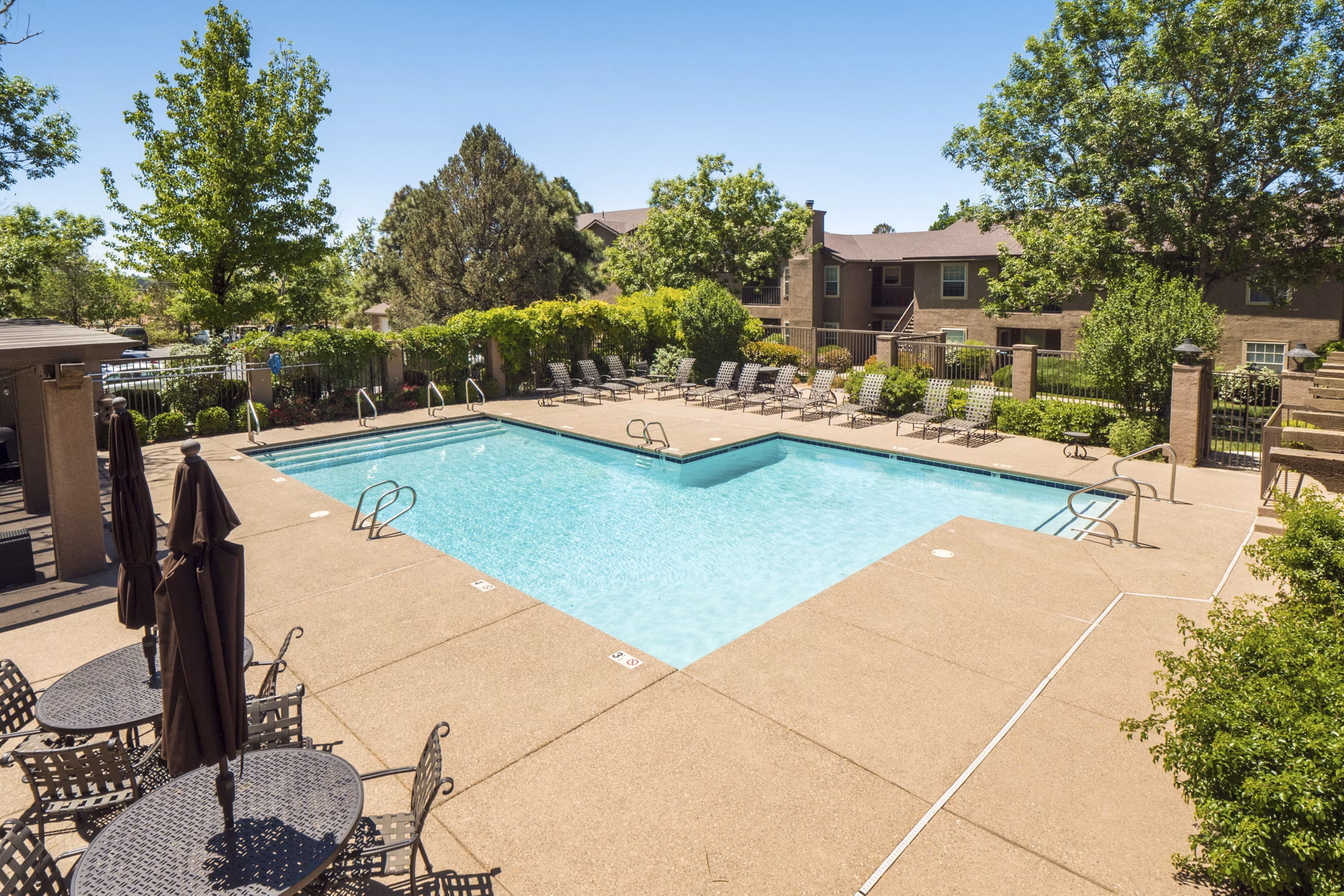 Resort-style pool with sun loungers at Hunters Ridge Apartments, a Greystar luxury community