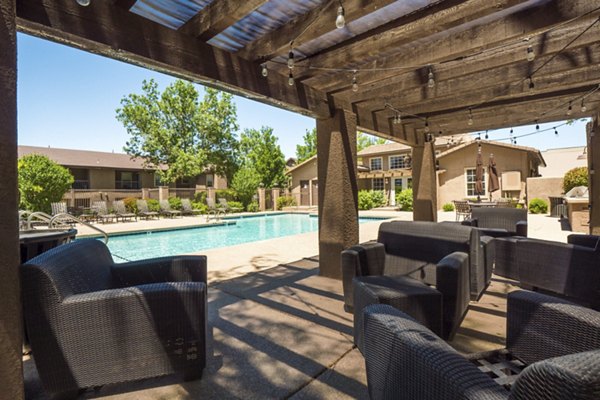 Relaxing patio with outdoor seating at Hunters Ridge Apartments, ideal for leisure or gatherings in a serene setting