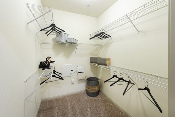 Cozy bedroom with elegant decor and large windows at Regard at Med Center Apartments luxury community