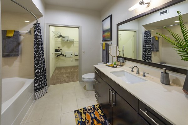 Elegant bathroom with marble countertops at Regard at Med Center Apartments, featuring modern fixtures and spacious design in Houston luxury living
