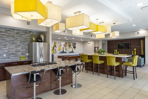 Clubhouse featuring modern lounge seating and billiards at Regard at Med Center Apartments