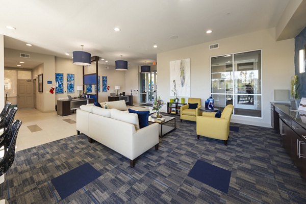 Clubhouse featuring modern design and communal seating at Regard at Med Center Apartments