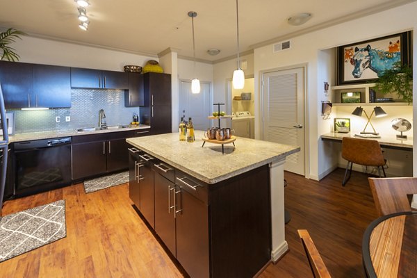 Kitchen featuring marble countertops and stainless steel appliances at Regard at Med Center Apartments