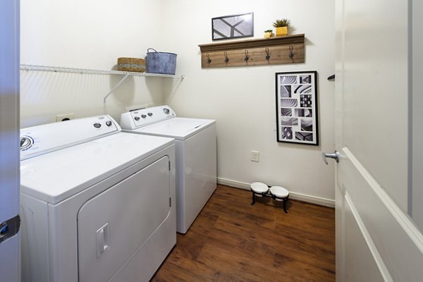 Laundry room with modern appliances at Regard at Med Center Apartments, offering convenience and style for residents