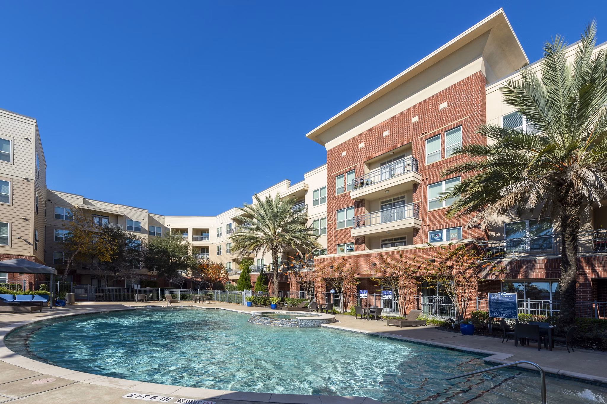 Resort-style pool with lounge chairs at Regard at Med Center Apartments, ideal for relaxation and leisure