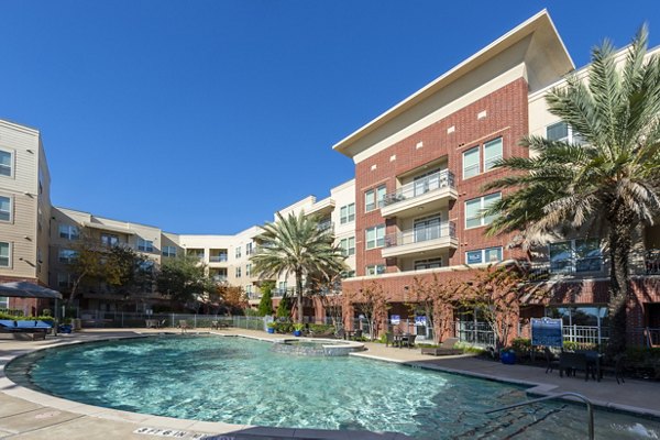 Resort-style pool with lounge chairs at Regard at Med Center Apartments, ideal for relaxation and leisure
