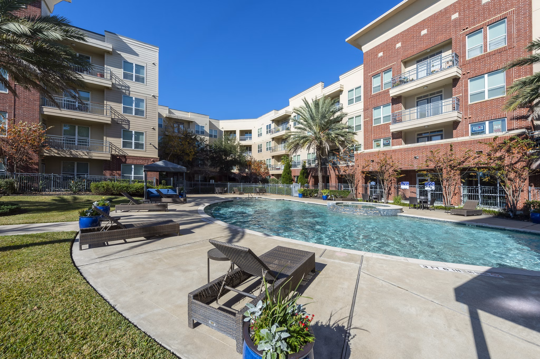 Rooftop pool with lounge seating at Regard at Med Center Apartments in Houston
