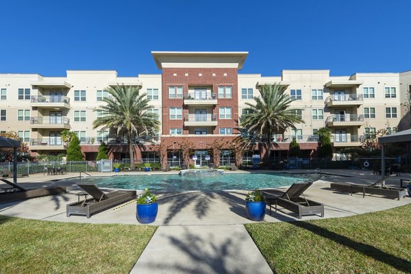 Rooftop pool with lounge seating at Regard at Med Center Apartments