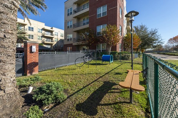 Outdoor recreation area featuring lush gardens at Regard at Med Center Apartments