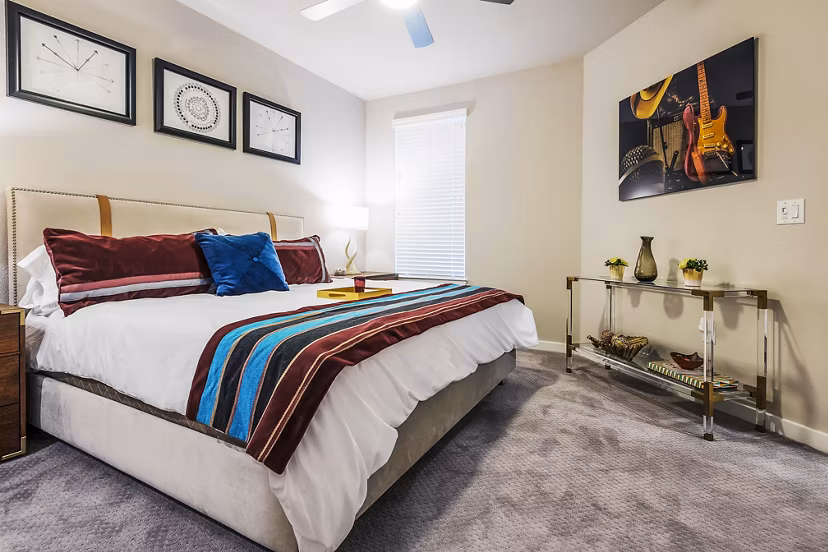 Luxurious bedroom with modern furnishings at Tribute at the Rim Apartments, ideal for comfortable living