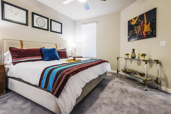 Luxurious bedroom with modern furnishings at Tribute at the Rim Apartments, ideal for comfortable living