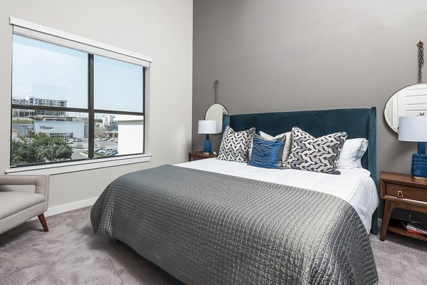 Cozy bedroom with modern decor at Tribute at the Rim Apartments