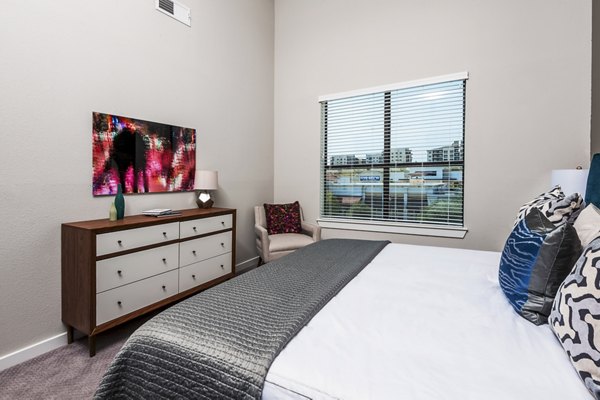 Cozy bedroom with modern decor at Tribute at the Rim Apartments in San Antonio