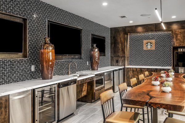 Clubhouse with stylish seating and modern design at Tribute at the Rim Apartments, offering luxury amenities and community spaces