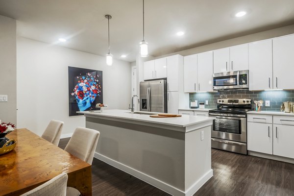 Modern kitchen with stainless appliances at Tribute at the Rim Apartments