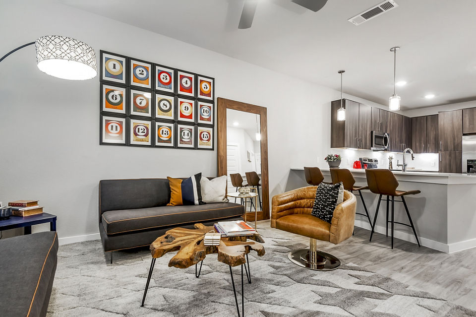 Spacious living room featuring modern decor at Tribute at the Rim Apartments, offering luxury living in a vibrant community setting