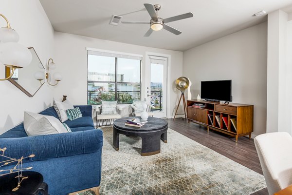 Modern living room with stylish decor at Tribute at the Rim Apartments, featuring a spacious layout and elegant lighting
