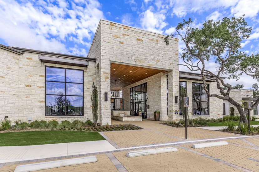 Modern clubhouse featuring stylish seating and a large TV at TruNorth at Bulverde Apartments