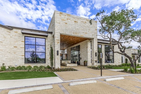 Modern clubhouse featuring stylish seating and a large TV at TruNorth at Bulverde Apartments