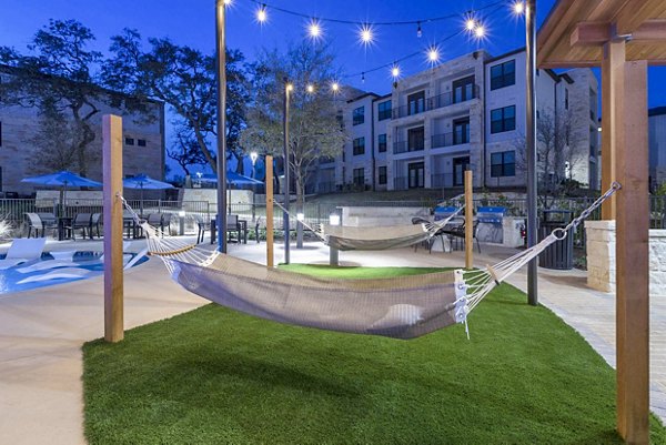 TruNorth at Bulverde: Modern patio with cozy seating and lush greenery, ideal for relaxation at luxury apartments