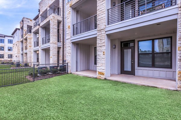 TruNorth at Bulverde Apartments: Modern patio with cozy seating and greenery in a luxury apartment setting