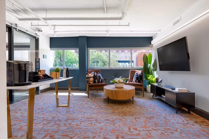 Modern clubhouse with comfortable seating and entertainment options at The Accolade on Chestnut Apartments