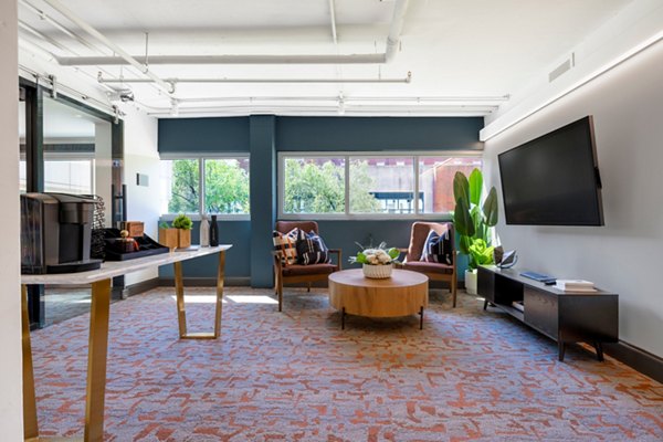 Modern clubhouse with comfortable seating and entertainment options at The Accolade on Chestnut Apartments