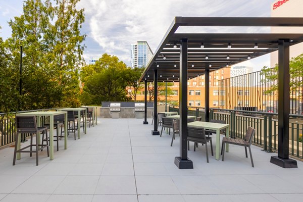 Modern grill area with seating at The Accolade on Chestnut Apartments, perfect for outdoor cooking and socializing