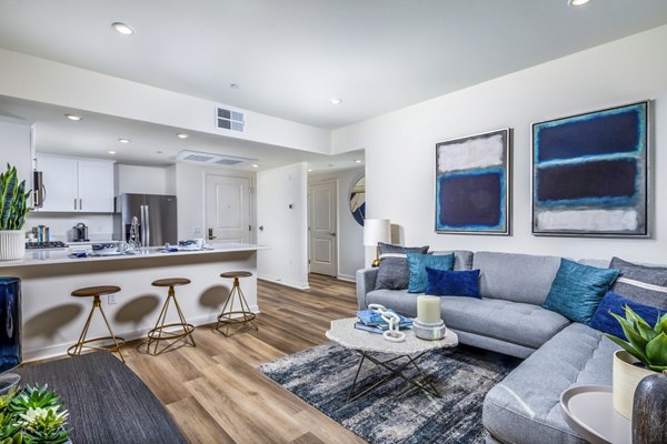 Spacious living room with modern design at Azul Chula Vista Apartments, featuring stylish furniture and abundant natural light