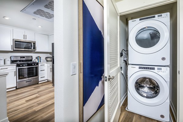 Laundry room with modern machines at Azul Chula Vista Apartments, providing convenient facilities for residents seeking luxury living