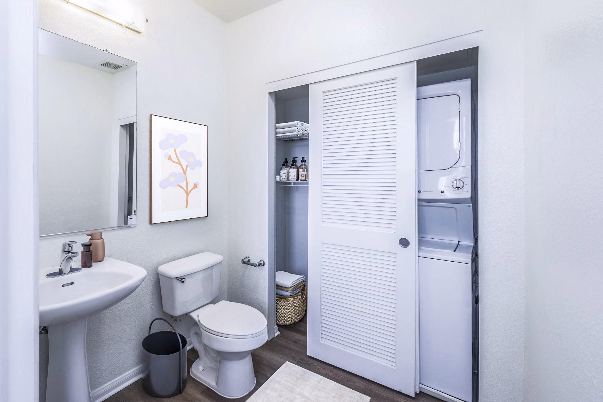 Bath and laundry room featuring modern fixtures at The Heritage Apartments