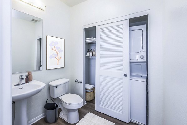 Bath and laundry room featuring modern fixtures at The Heritage Apartments
