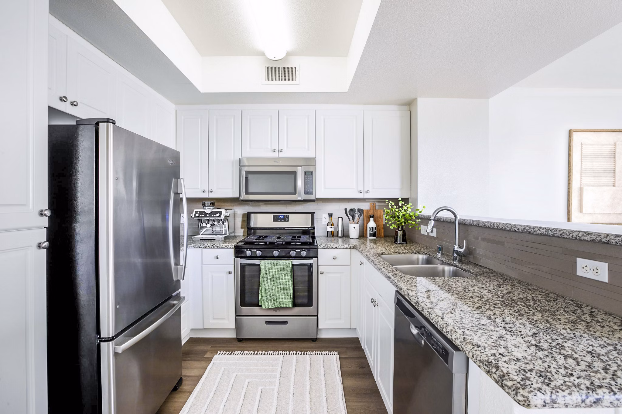 Modern kitchen with stainless steel appliances in The Heritage Apartments