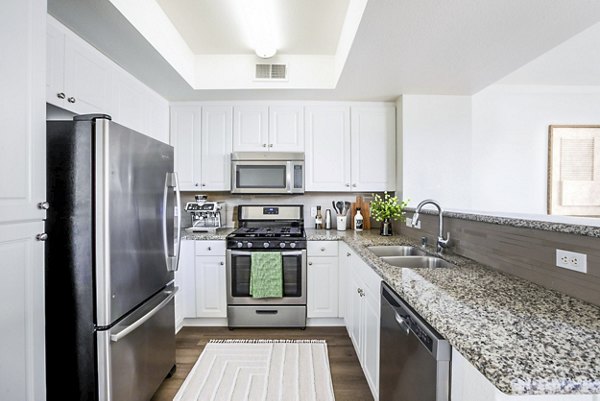 Modern kitchen with stainless steel appliances in The Heritage Apartments