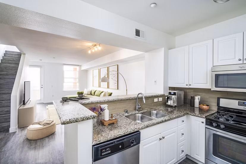 Modern kitchen featuring sleek countertops and stainless steel appliances at Gema Apartments, a Greystar luxury property