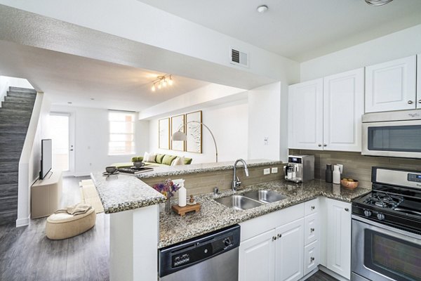 Modern kitchen featuring sleek countertops and stainless steel appliances at Gema Apartments, a Greystar luxury property