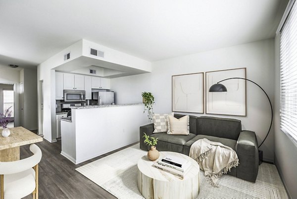 Open-concept living and dining room with contemporary furnishings at The Heritage Apartments
