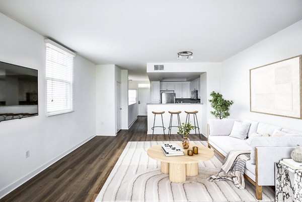 Living room with modern decor and natural light at The Heritage Apartments