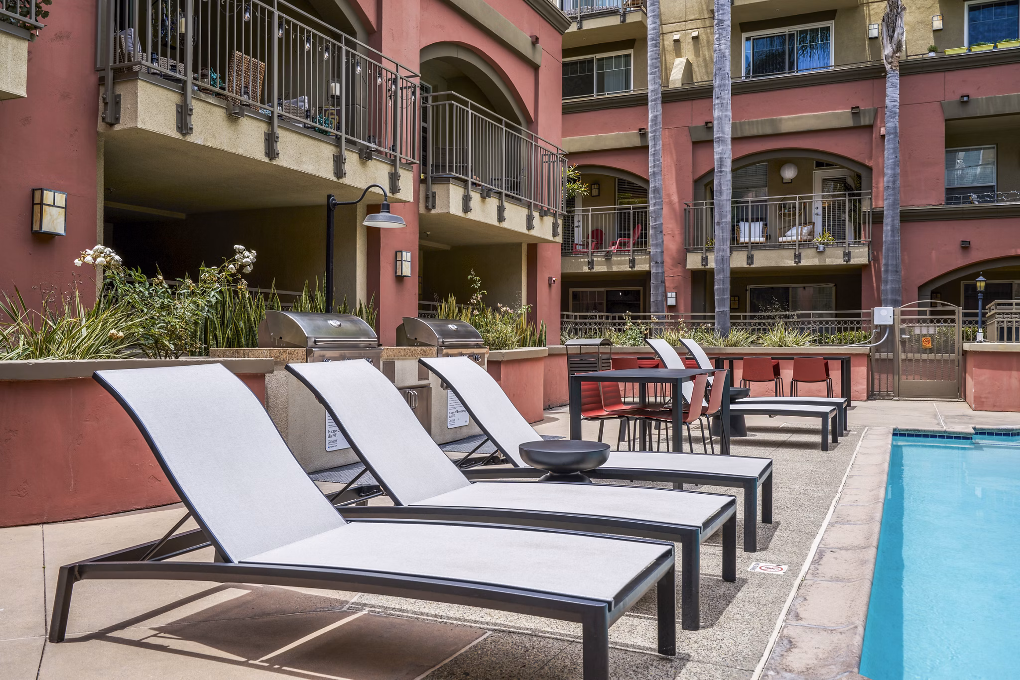 Inviting grill area next to a sparkling pool at Gema Apartments