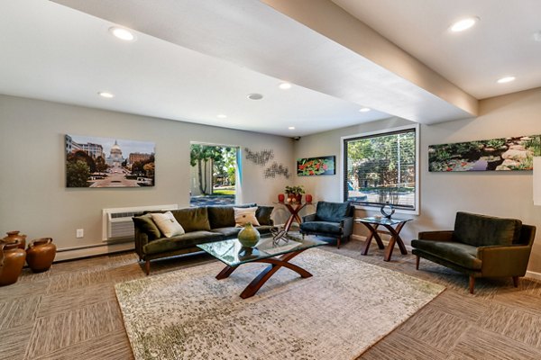 Modern clubhouse with sleek furnishings and game area at Sycamore Woods Apartments
