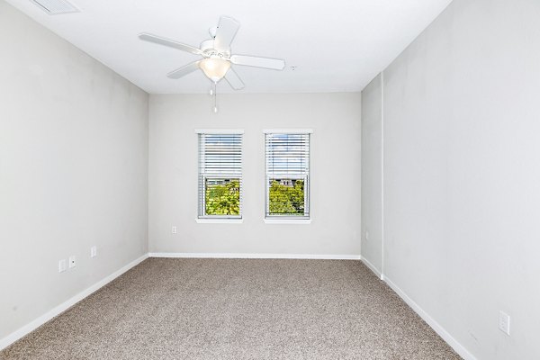 Cozy bedroom with elegant furnishings at Parkside at Avalon Park Apartments