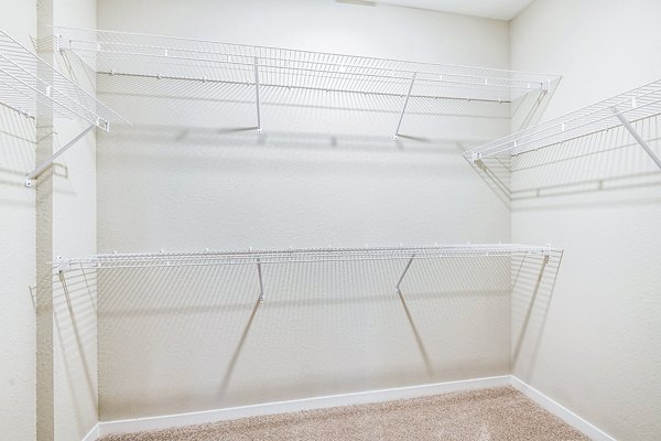Organized closet in a modern bedroom at Parkside at Avalon Park Apartments