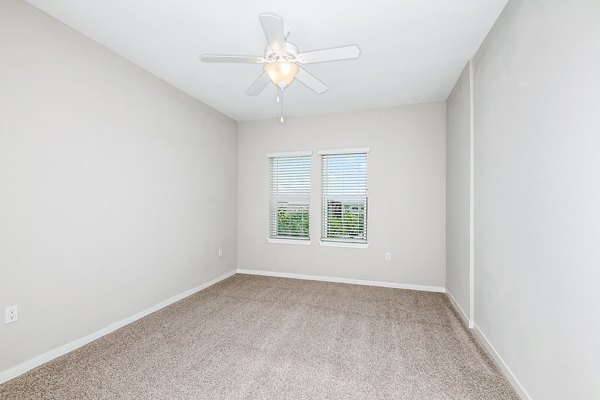 Luxurious bedroom featuring plush bedding and elegant decor in Parkside at Avalon Park Apartments
