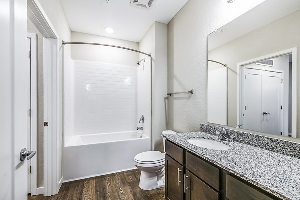 Bathroom with sleek fixtures and marble countertop at Parkside at Avalon Park Apartments