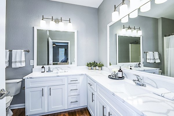Modern bathroom with marble countertops at Parkside at Avalon Park Apartments